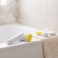 Spin Scrubber resting on the edge of a bathtub