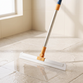 Floor Squeegee pushing water across bathroom tile