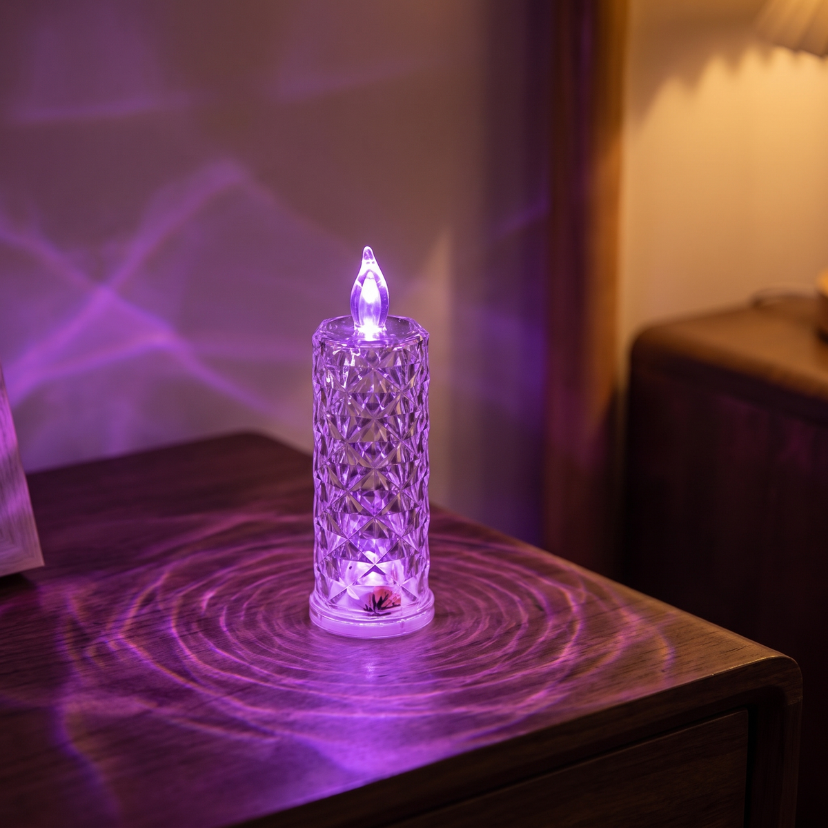 Luniee Crystal Glow Candle in purple, refracted purple light on the table and wall