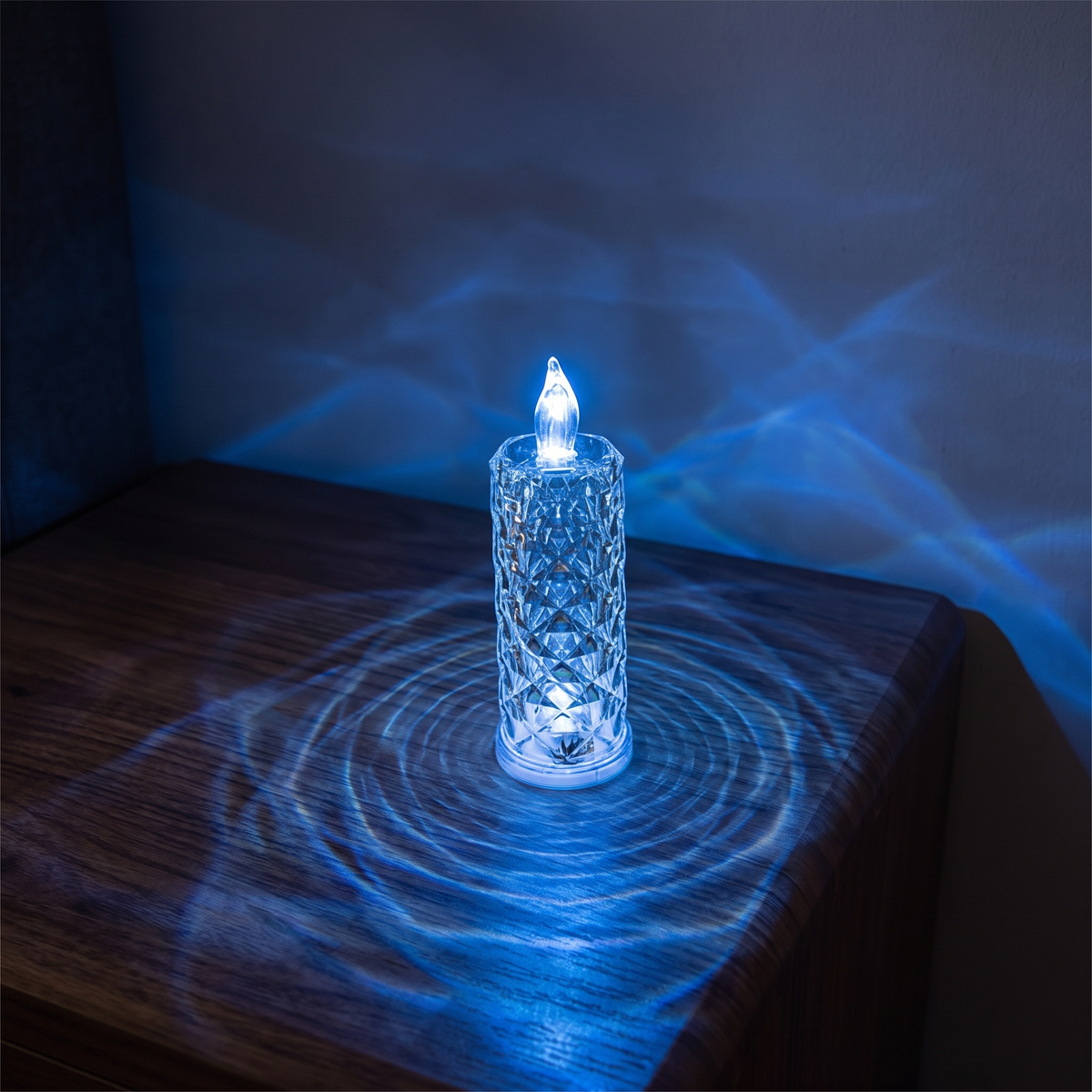 Luniee Crystal Glow Candle in blue, refracted blue light on the table and wall